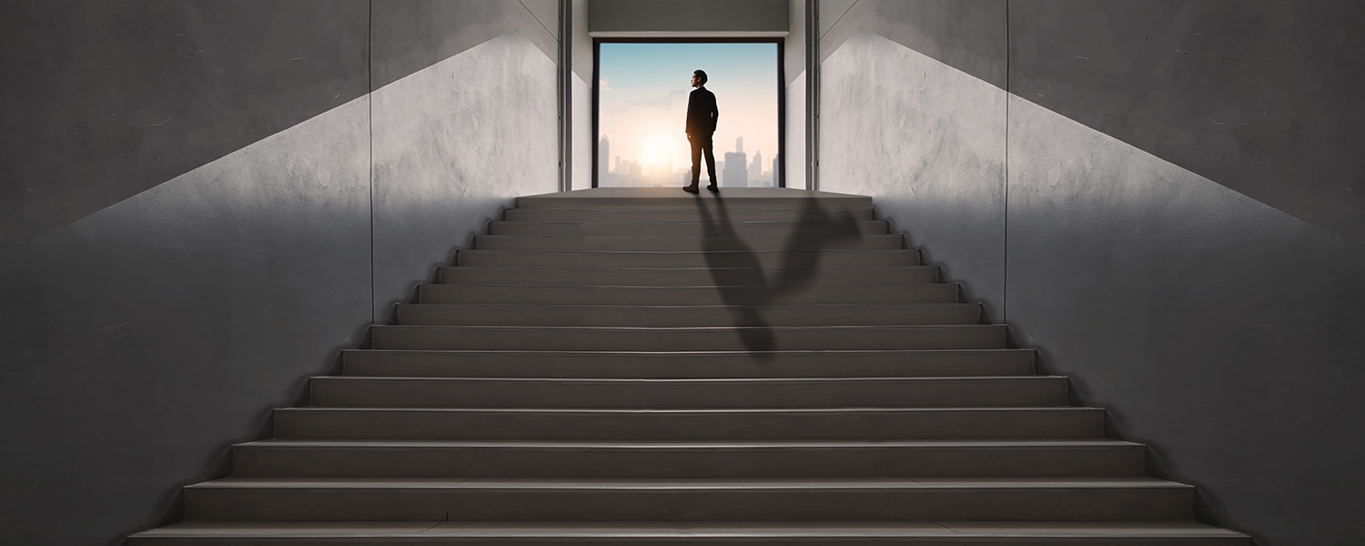 Business man at top of stairs